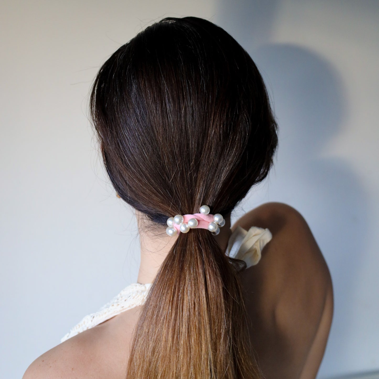 Dear Cleo coral pink pearl hair tie styled